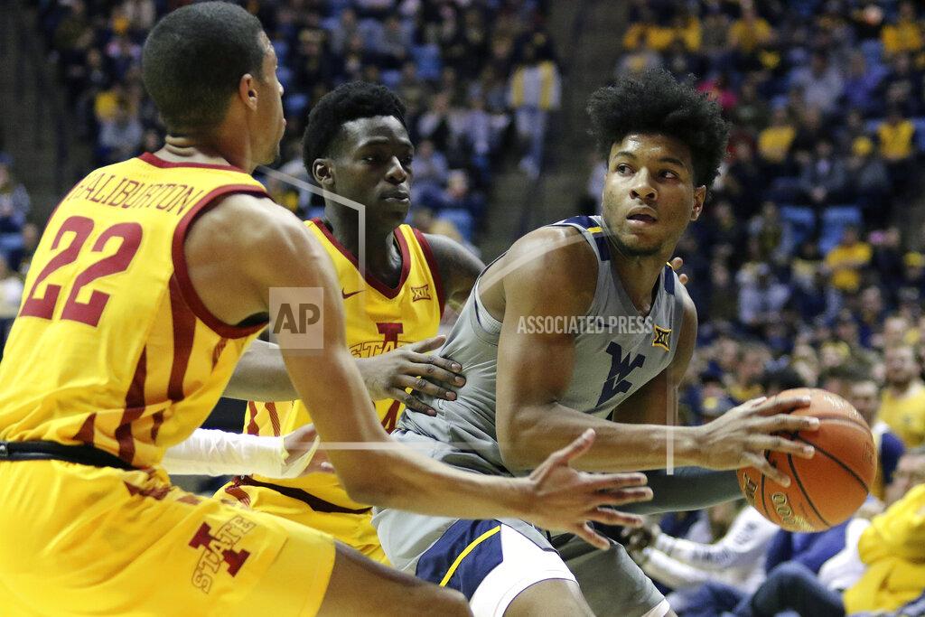Kathleen Batten West Virginia guard Miles McBride (4) goes to pass the ball as he is defended by Iowa State guards Tyrese Haliburton (22) and Terrence Lewis (24) during the first half of an NCAA college basketball game Wednesday, Feb. 5, 2020, in Morgantown, W.Va. (AP Photo/Kathleen Batten)