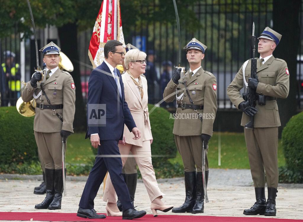 Czarek Sokolowski Lithuanian Prime Minister Ingrida Simonyte, centre, being greeted by Poland's Prime Minister Mateusz Morawiecki on a visit for talks that include the region's security in the face of migrant pressure on the two countries' borders with Belarus, in Warsaw, Poland, on Friday, Sept. 17, 2021. (AP Photo/Czarek Sokolowski)
