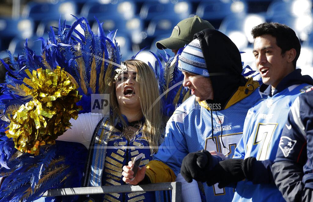 Steven Senne Los Angeles Chargers fans cheer before an NFL divisional playoff football game between the Chargers and the New England Patriots , Sunday, Jan. 13, 2019, in Foxborough, Mass. (AP Photo/Steven Senne)
