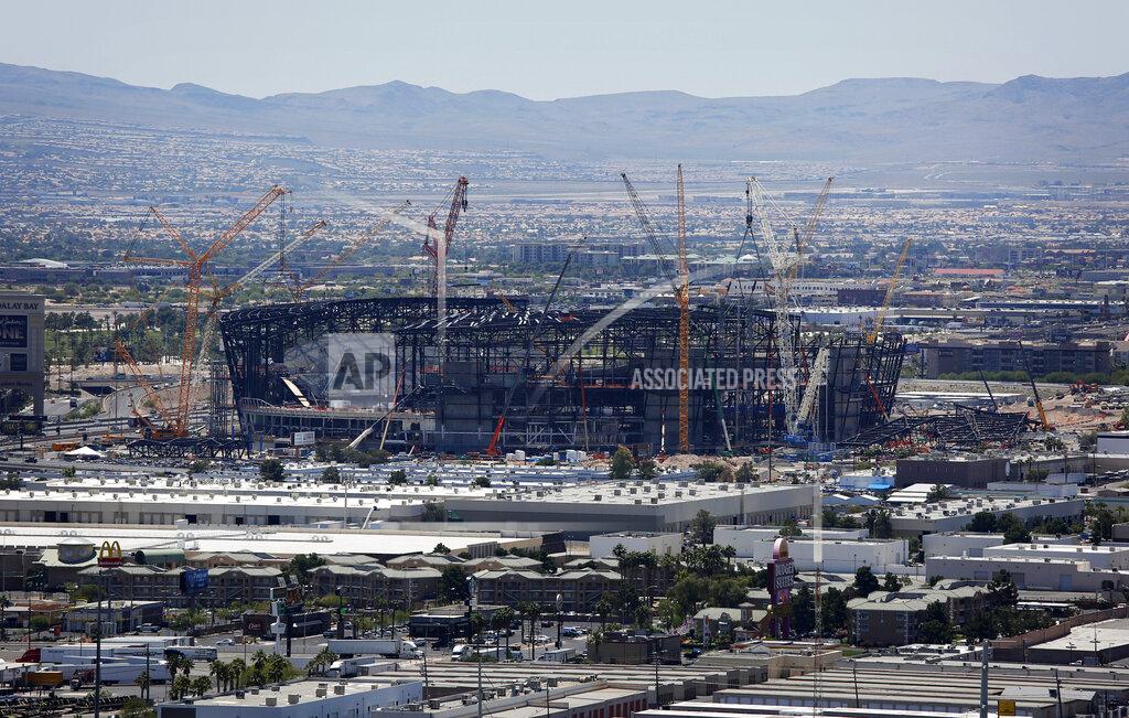John Locher FILE - In this June 4, 2019, file photo, construction cranes surround the football stadium under construction in Las Vegas. Hard to imagine now, but as recently as 15 years ago the NFL rejected Super Bowl advertising from Las Vegas tourism officials. As late as four years ago it forced organizers of a fantasy football convention in the gambling city to cancel their show because Dallas Cowboys quarterback Tony Romo was going to be a featured guest. (AP Photo/John Locher, File)