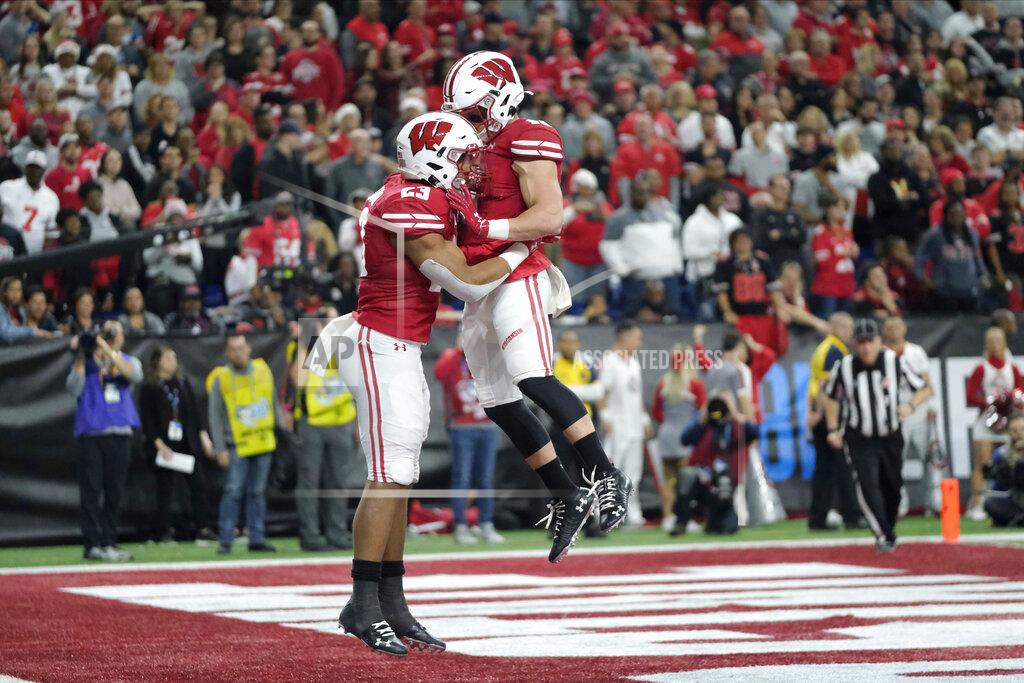Aj Mast Wisconsin running back Jonathan Taylor, left, is congratulated by Jack Dunn after running for a touchdown during the first half of the Big Ten championship NCAA college football game against Ohio State, Saturday, Dec. 7, 2019, in Indianapolis. (AP Photo/AJ Mast)