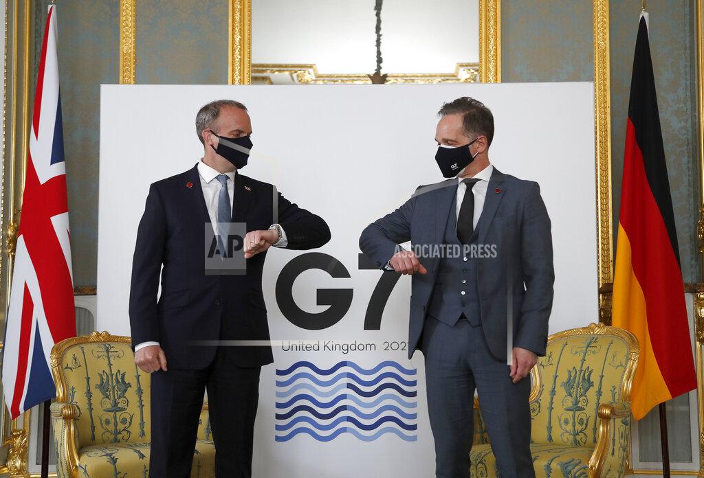 Britain's Foreign Secretary Dominic Raab, left, poses for a photo with his German counterpart Heiko Maas ahead of bi-lateral talks during the G7 foreign ministers' meeting in London, Wednesday, May 5, 2021. Diplomats from the group of wealthy nations are meeting in London for their first face-to-face gathering in two years. (AP Photo/Frank Augstein, Pool)