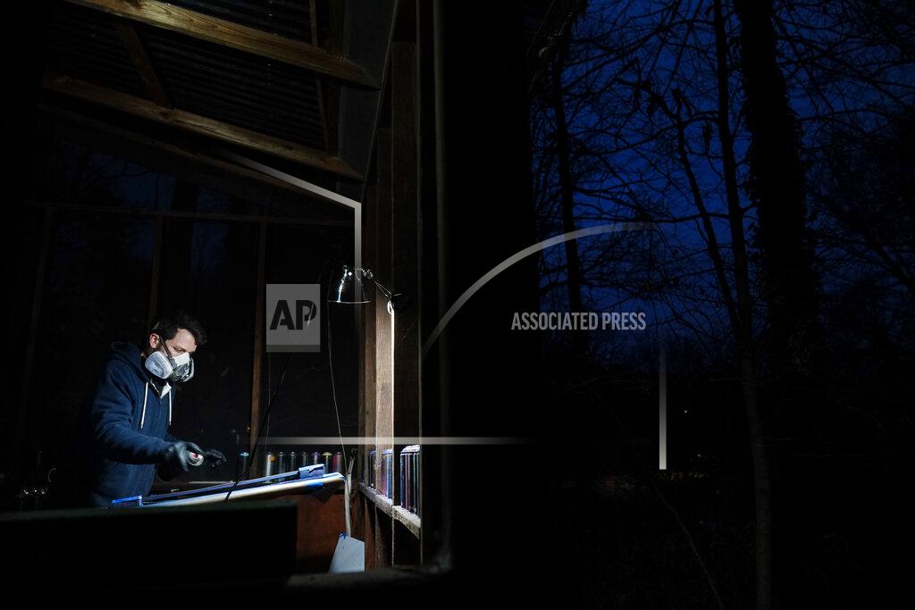 Brynn Anderson Artist Brandon Litman paints a U.S. Senator-elect Jon Ossoff, D-Ga., campaign poster for voters after Georgia's Senate runoff race on Saturday, Jan. 9, 2021, in Atlanta. (AP Photo/Brynn Anderson)