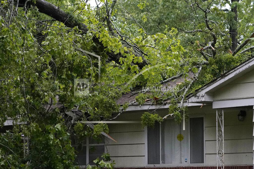 Rogelio V. Solis Tree branches poke through this northeast Jackson, Miss., home, brought down by high winds and severe weather, Tuesday, May 4, 2021. The severe weather was not unexpected, since the state was hit with a number of tornadoes on Sunday. (AP Photo/Rogelio V. Solis)