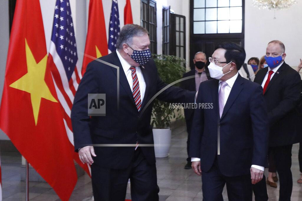 Bui Lam Khanh U.S. Secretary of State Mike Pompeo, left, and Vietnamese Foreign Minister Pham Binh Minh walk for a meeting in Hanoi, Vietnam, Friday, Oct. 30, 2020. Pompeo is wrapping up an anti-China tour of Asia in Vietnam as the fierce American presidential election race enters its final stretch. (Bui Lam Khanh/VNA via AP)