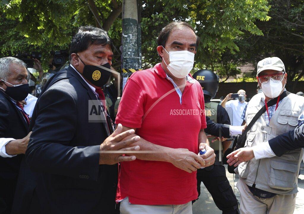 Martin Mejia Popular Action party presidential candidate Yonhy Lescano, center, arrives to vote during general elections in Lima, Peru, Sunday, April 11, 2021. (AP Photo/Martin Mejia)