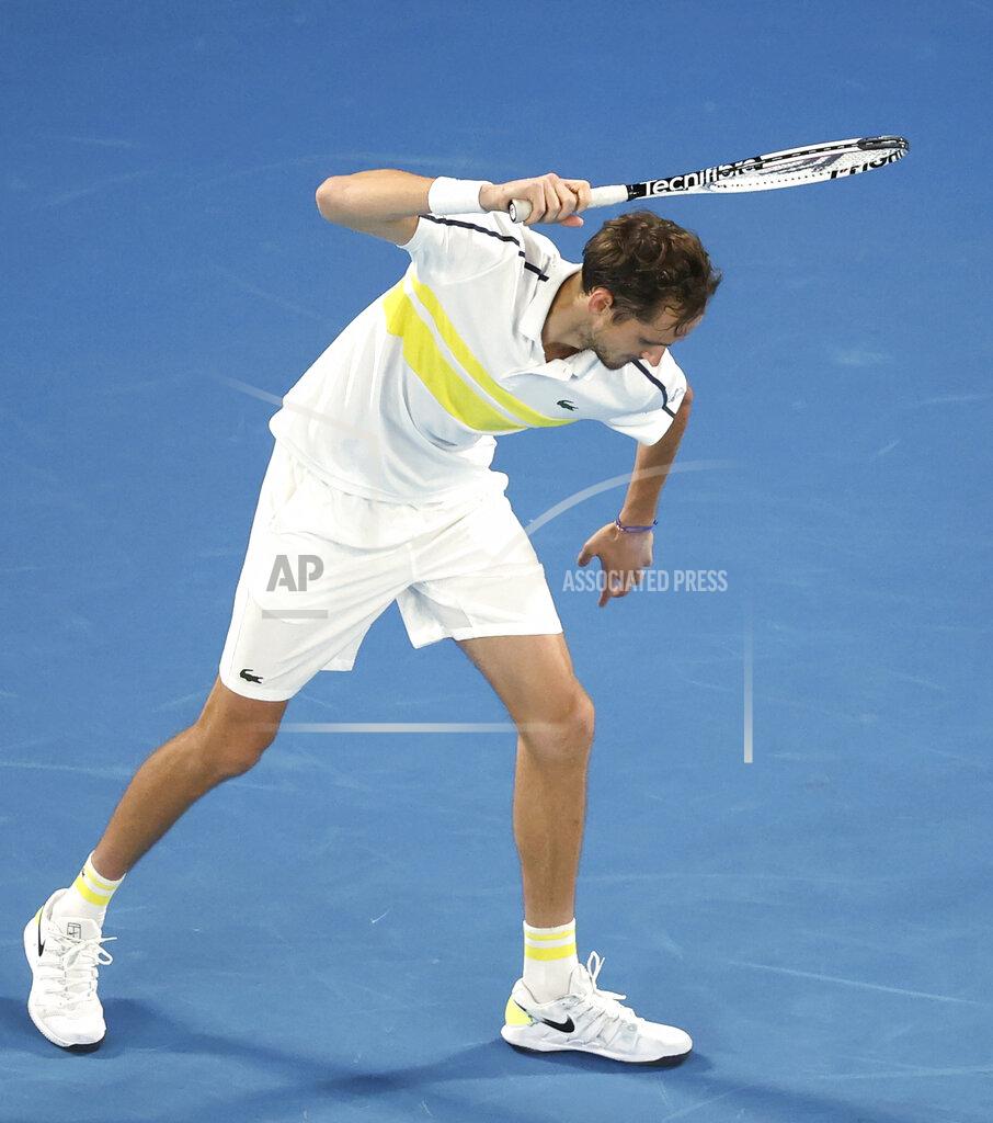 Hamish Blair Russia's Daniil Medvedev raises his racket as if to smash it on the court while playing Serbia's Novak Djokovic during the men's singles final at the Australian Open tennis championship in Melbourne, Australia, Sunday, Feb. 21, 2021. (AP Photo/Hamish Blair)