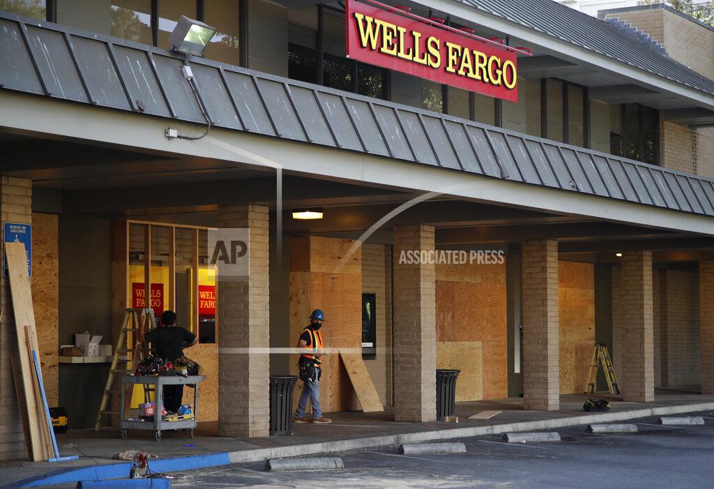 Ben Margot Workers board up a Wells Fargo branch Tuesday, June 2, 2020, in Redwood City, Calif. (AP Photo/Ben Margot)