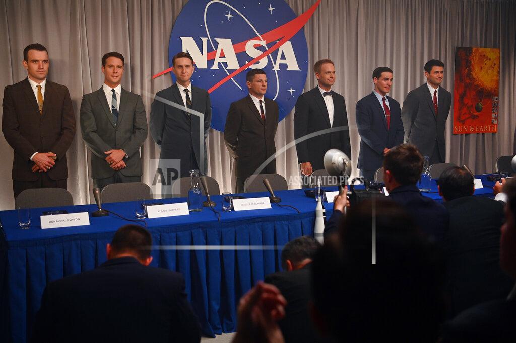 Uncredited This image released by Disney Plus shows, from left, Micah Stock, Jake McDornan, Aaron Staton, Michael Trotter, Patrick J. Adams, Colin O'Donoghue and James Lafferty in a scene from "The Right Stuff," premiering Oct. 9. (Disney Plus via AP)