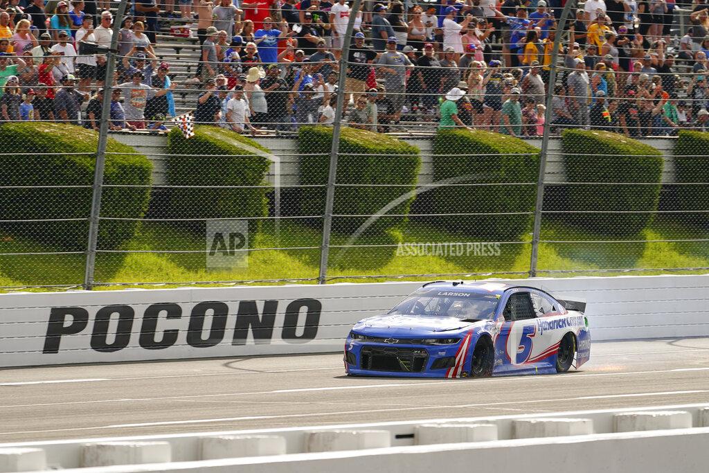 Matt Slocum Sparks fly from under the race car of Kyle Larson (5) as he drives towards the finish line after being passed by Alex Bowman to lose the lead on the last lap of a NASCAR Cup Series auto race at Pocono Raceway, Saturday, June 26, 2021, in Long Pond, Pa. Bowman one the race. (AP Photo/Matt Slocum)