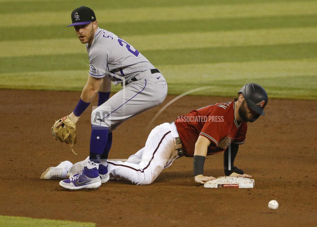 Darryl Webb Colorado Rockies shortstop Trevor Story, left, looks for the ball after Arizona Diamondbacks' Wyatt Mathisen dove back into second base during the fourth inning of a baseball game Sunday, Sept. 27, 2020, in Phoenix. (AP Photo/Darryl Webb)