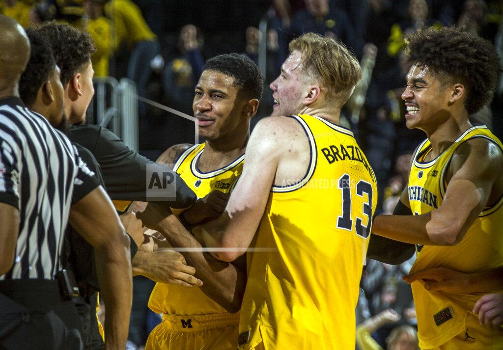 Tony Ding Michigan guard Charles Matthews, center, celebrates his game-winning buzzer-beater with forward Ignas Brazdeikis (13) and guard Jordan Poole, right, after an NCAA college basketball game against Minnesota at Crisler Center in Ann Arbor, Mich., Tuesday, Jan. 22, 2019. Michigan won 59-57. (AP Photo/Tony Ding)