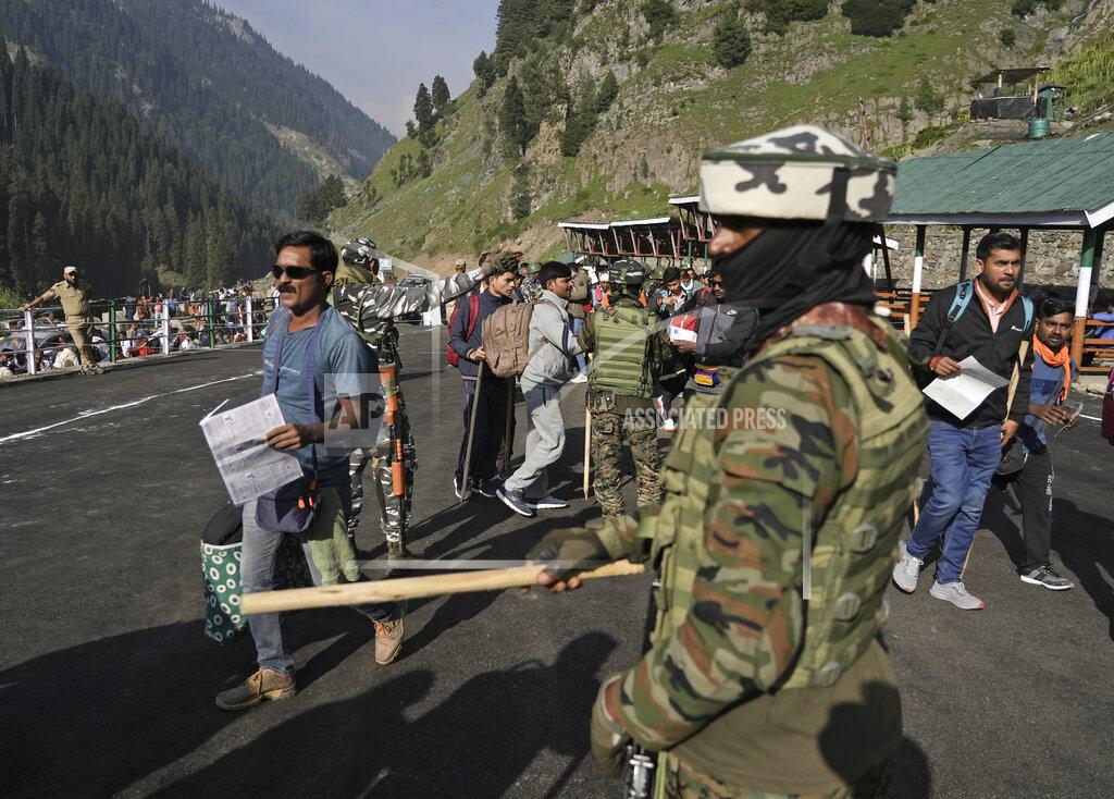 Uncredited Soldiers stand guard as Hindu devotees begin the Amarnath Yatra annual pilgrimage to to an icy Himalayan cave, in Chandanwari, Pahalgam, south of Srinagar, Indian-controlled Kashmir, Thursday, June 30, 2022. Officials say pilgrims face heightened threat of attacks from rebels fighting against Indian rule and have for the first time tagged devotees with wireless tracking system. They also have deployed drones for surveillance. (AP Photo)