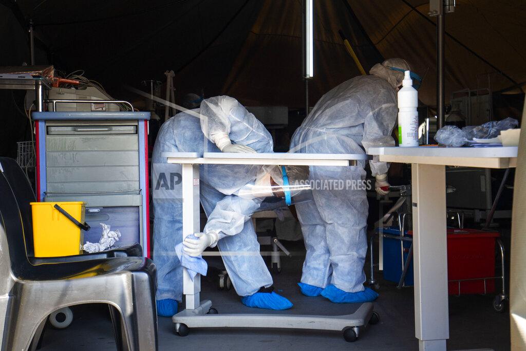 Jerome Delay Medical staff cleans a tent where Covid-19 patients are being treated at the Tshwane District Hospital in Pretoria, South Africa, Friday July 10, 2020. Health Minister Zweli Mkhize this week said South Africa could run out of available hospital beds within the month. "The storm that we have consistently warned South Africans about is now arriving," he told lawmakers. The African continent overall has over 523,000 confirmed virus cases after passing the half-million milestone on Wednesday. But shortages in testing materials mean the true number is unknown.(AP Photo/Jerome Delay)