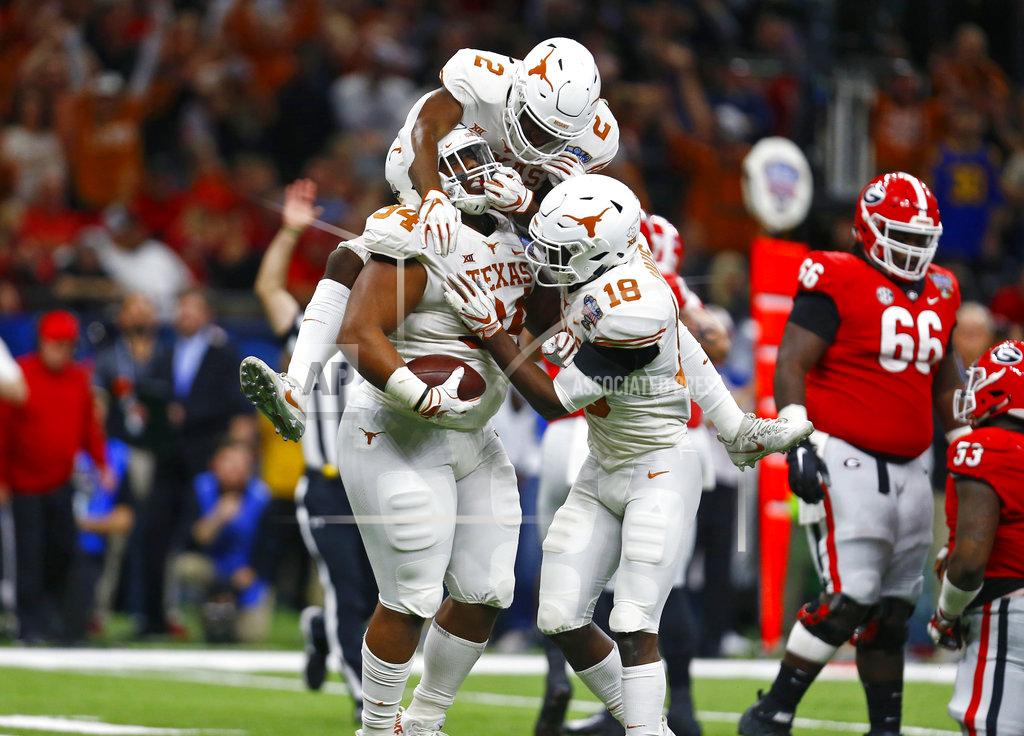 Butch Dill Texas defensive lineman Gerald Wilbon (94) celebrates his fumble recovery with defensive backs Kris Boyd (2) and Davante Davis (18) during the first half of the Sugar Bowl NCAA college football game against Georgia in New Orleans, Tuesday, Jan. 1, 2019. (AP Photo/Butch Dill)