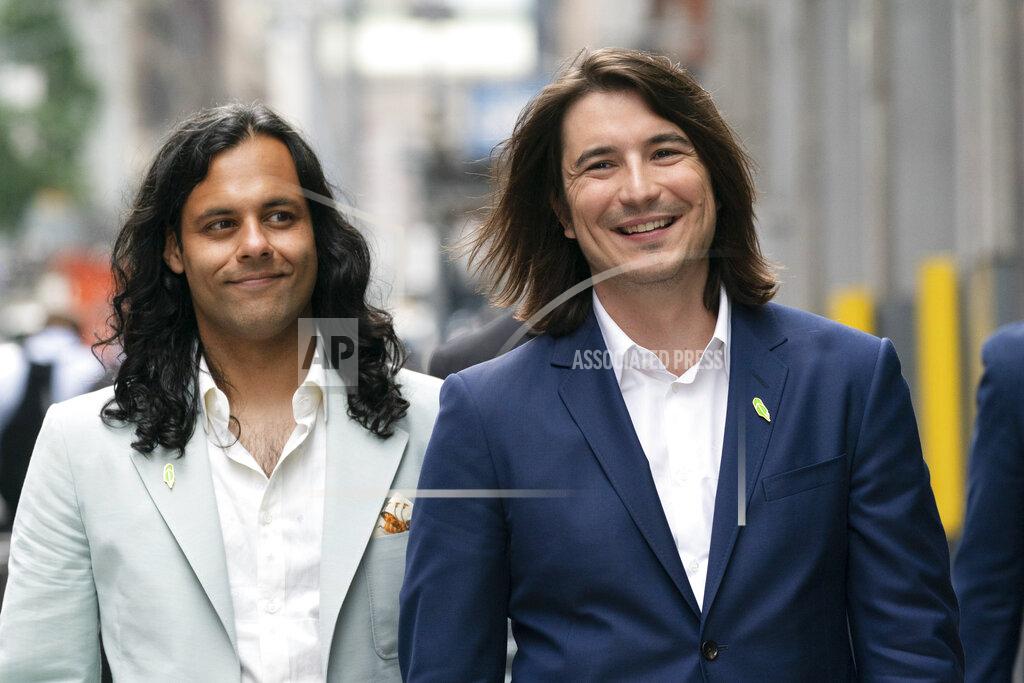 Mark Lennihan Vladimir Tenev, CEO and Co-Founder of Robinhood, right, walks in New York's Times Square with fellow Co-Founder Baiju Bhatt following their company's IPO, Thursday, July 29, 2021. Robinhood is selling its own stock on Wall Street, the very place the online brokerage has rattled with its stated goal of democratizing finance. Through its app, Robinhood has introduced millions to investing and reshaped the brokerage industry, all while racking up a long list of controversies in less than eight years. (AP Photo/Mark Lennihan)