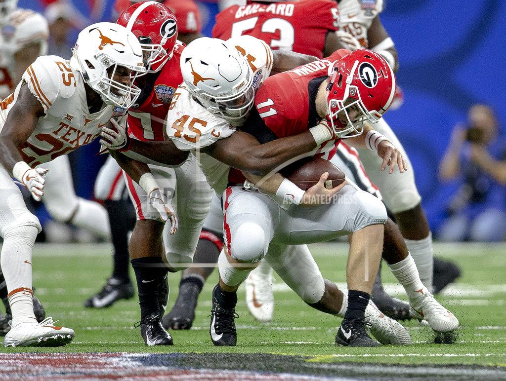 Nick Wagner Texas linebacker Anthony Wheeler (45) sacks Georgia quarterback Jake Fromm (11) during the first half of the Sugar Bowl NCAA college football game Tuesday, Jan. 1, 2019, in New Orleans. (Nick Wagner/Austin American-Statesman via AP)