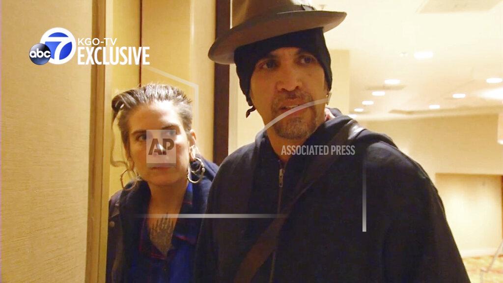 Uncredited FILE - This file photo from exclusive video provided by San Francisco TV station KGO-TV, made late Sunday, Dec. 4, 2016, shows Derick Ion Almena, right, and Micah Allison, the couple who operated the Ghost Ship warehouse where dozens died in a fire, at an Oakland, Calif., courthouse. Almena, facing a second trial after a 2016 fire killed 36 partygoers at a San Francisco Bay Area warehouse he's accused of illegally converting into a cluttered artists enclave, is expected to plead guilty later this month, relatives of several of the victims said. Almena, 50, is expected to plead guilty to 36 counts of involuntary manslaughter on Jan. 22, 2021. (KGO-TV via AP, File)