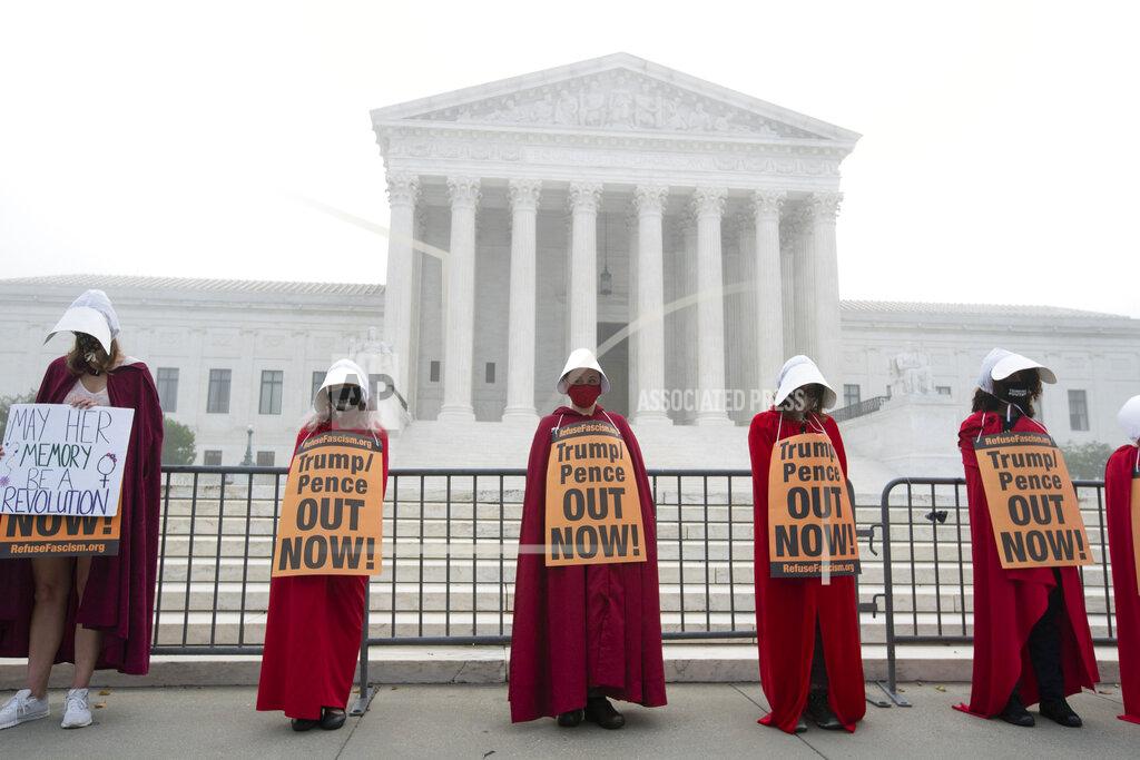 Jose Luis Magana Activists opposed to the confirmation of President Donald Trump's Supreme Court nominee, Judge Amy Coney Barrett, dressed as characters from "The Handmaid's Tale," protest at the Supreme Court on a foggy day, Thursday, Oct. 22, 2020 in Washington. (AP Photo/Jose Luis Magana)