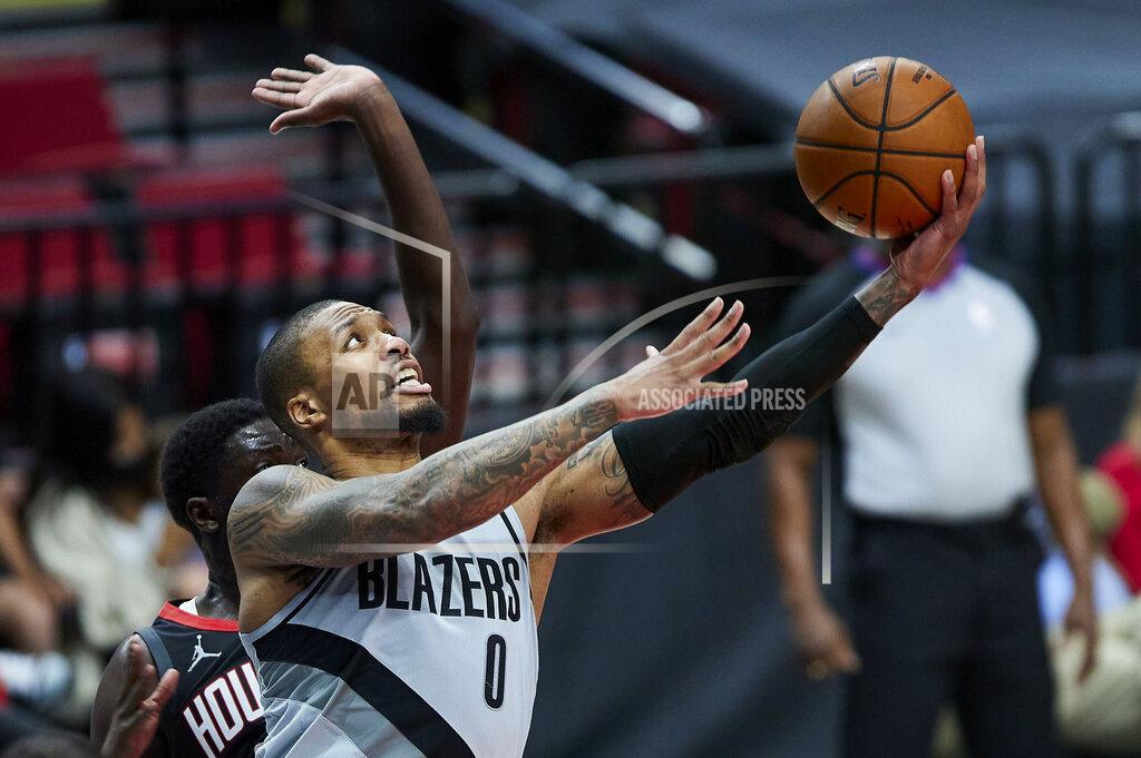 Craig Mitchelldyer Portland Trail Blazers guard Damian Lillard (0) shoots in front of Houston Rockets forward Khyri Thomas during the second half of an NBA basketball game in Portland, Ore., Monday, May 10, 2021. (AP Photo/Craig Mitchelldyer)