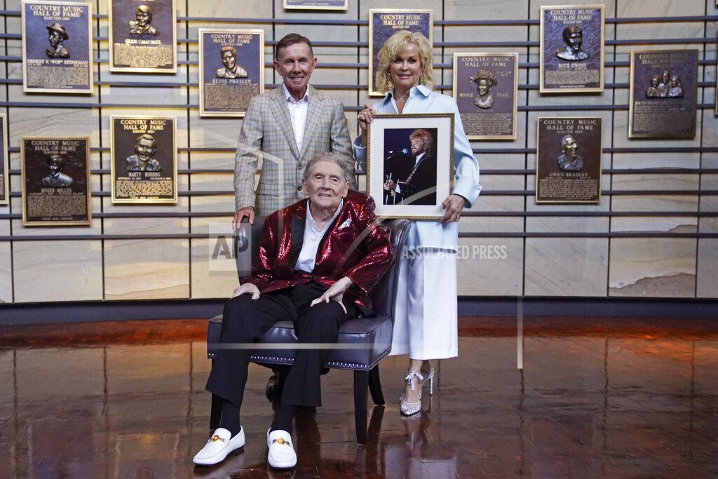 Mark Humphrey Music executive Joe Galante, left; singer Jerry Lee Lewis, center; and Lorrie Morgan, right, widow of country singer Keith Whitley; pose in the Country Music Hall of Fame Tuesday, May 17, 2022, in Nashville, Tenn. Galante, Lewis, and Whitley were announced Tuesday as the newest inductees. (AP Photo/Mark Humphrey)