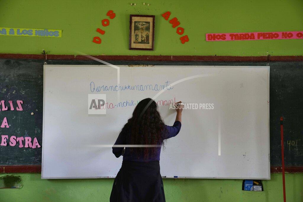 Martin Mejia Teacher Carmen Cazorla writes in the Quechua Indigenous language during a class on medicinal plants at a public primary school in Licapa, Peru, Wednesday, Sept. 1, 2021. “For 500 years Spanish has been imposed in a way that reflects the racist and classist values of Peruvian society,” said Cazorla, an anthropologist who also teaches Quechua at the Catholic University of Peru. (AP Photo/Martin Mejia)