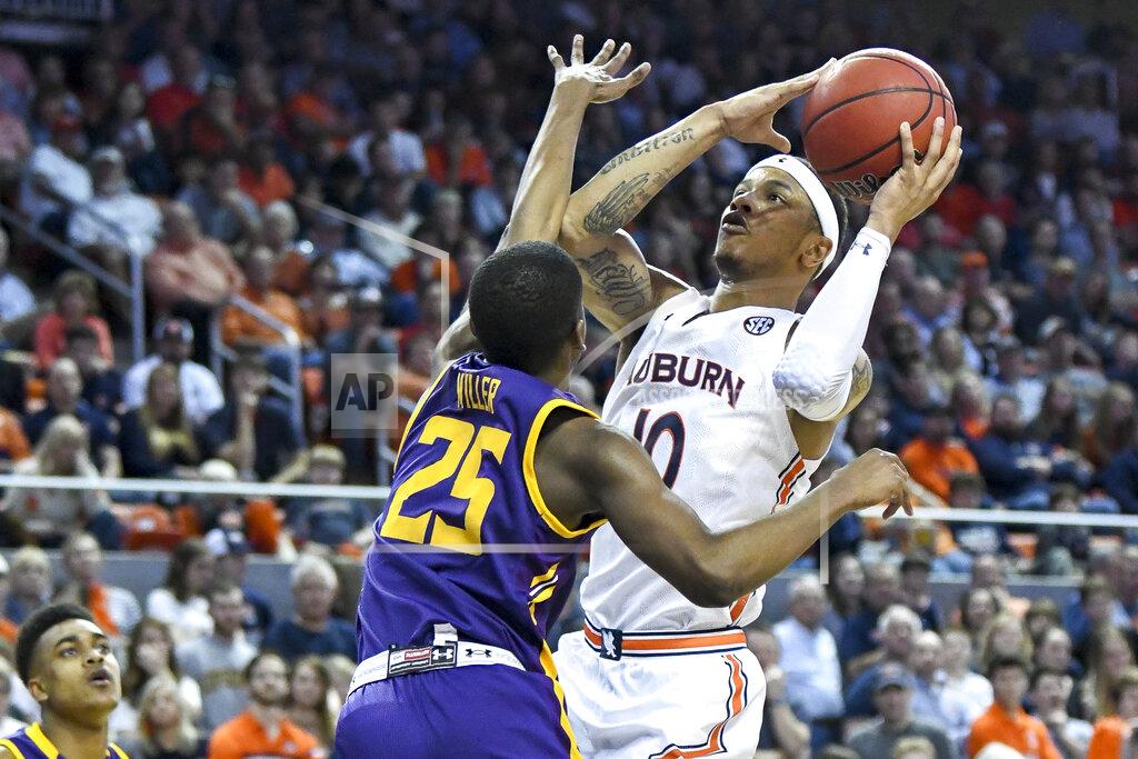 Julie Bennett Lipscomb guard Miles Miller (25) defends against a shot by Auburn guard Samir Doughty (10) during the second half of an NCAA college basketball game Sunday, Dec. 29, 2019, in Auburn, Ala. (AP Photo/Julie Bennett)