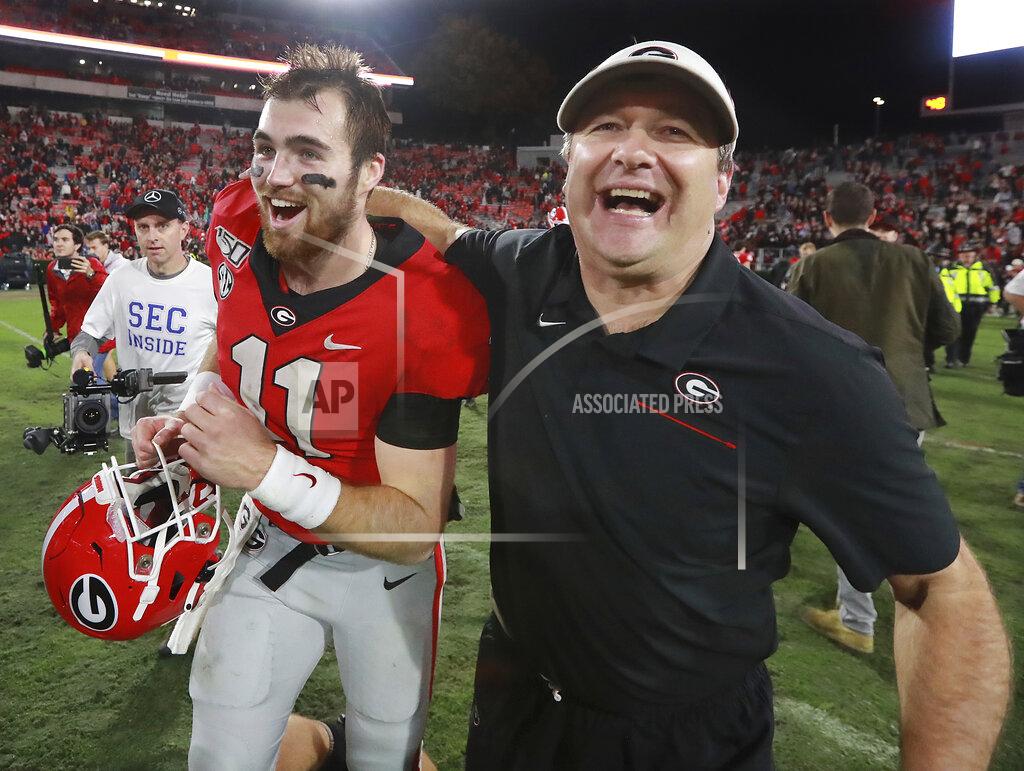 Curtis Compton FILE - In this Nov. 23, 2019, file photo, Georgia head coach Kirby Smart and quarterback Jake Fromm celebrate beating Texas A&M 19-13 in an NCAA college football game, in Athens, Ga. Heading into this year’s slate of conference title games a case could be made that No. 1 LSU (No. 2 CFP), No. 2 Ohio State (No. 1 CFP) and No. 3 Clemson (No. 3 CFP) have all done enough already to lose their conference championship games and still get in the College Football Playoff. (Curtis Compton/Atlanta Journal-Constitution via AP, File)