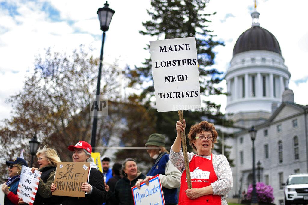 Robert F. Bukaty Protesters rally against the executive orders by Maine Gov. Janet Mills keep some of Maine businesses closed to help prevent the spread of coronavirus, Saturday, May 16, 2020, in Augusta, Maine. (AP Photo/Robert F. Bukaty)