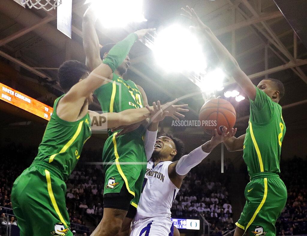 Ted S. Warren Washington guard David Crisp, second from right, is blocked by Oregon forward Kenny Wooten, second from left, Will Richardson, left, and Louis King, right, during the first half of an NCAA college basketball game, Saturday, March 9, 2019, in Seattle. (AP Photo/Ted S. Warren)