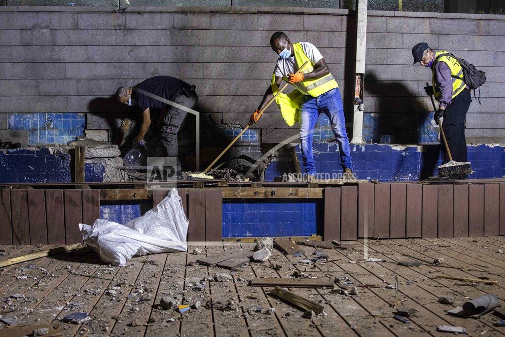 Tsafrir Abayov Israeli police inspect the damage at the site hit by a rocket fired by Palestinian militants from the Gaza Strip in the southern city of Ashdod, Israel, Tuesday, Sept. 15, 2020. The Israeli military says two rockets were fired from Gaza and one was intercepted by air defenses. Magen David Adom, the Israeli emergency service, says it treated two people for minor injuries from broken glass. (AP Photo/Tsafrir Abayov)