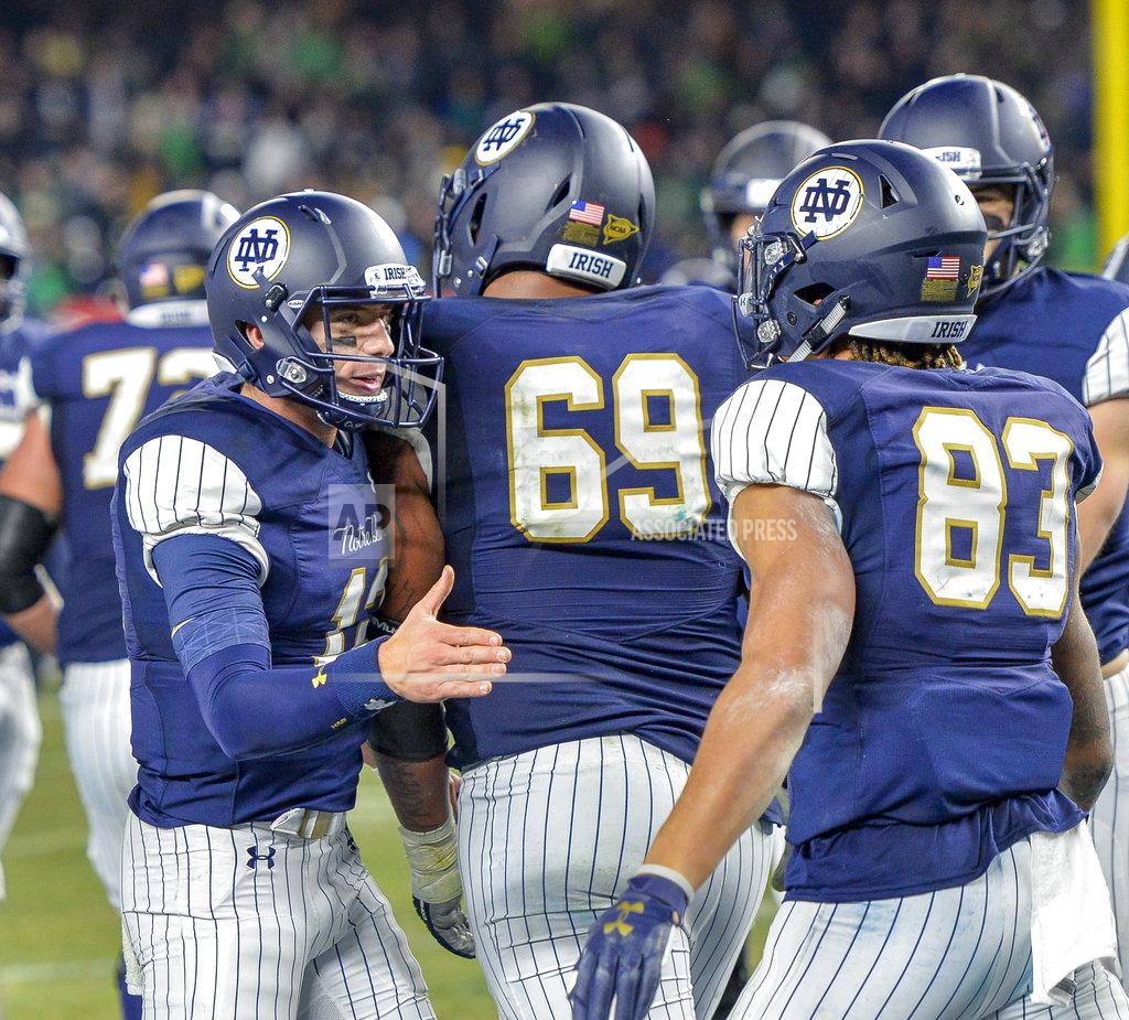Howard Simmons Notre Dame quarterback Ian Book (12) congratulates wide receiver Chase Claypool (83) after a touchdown against Notre Dame during an NCAA college football game, Saturday, Nov. 17, 2018, at Yankee Stadium in New York. (AP Photo/Howard Simmons)
