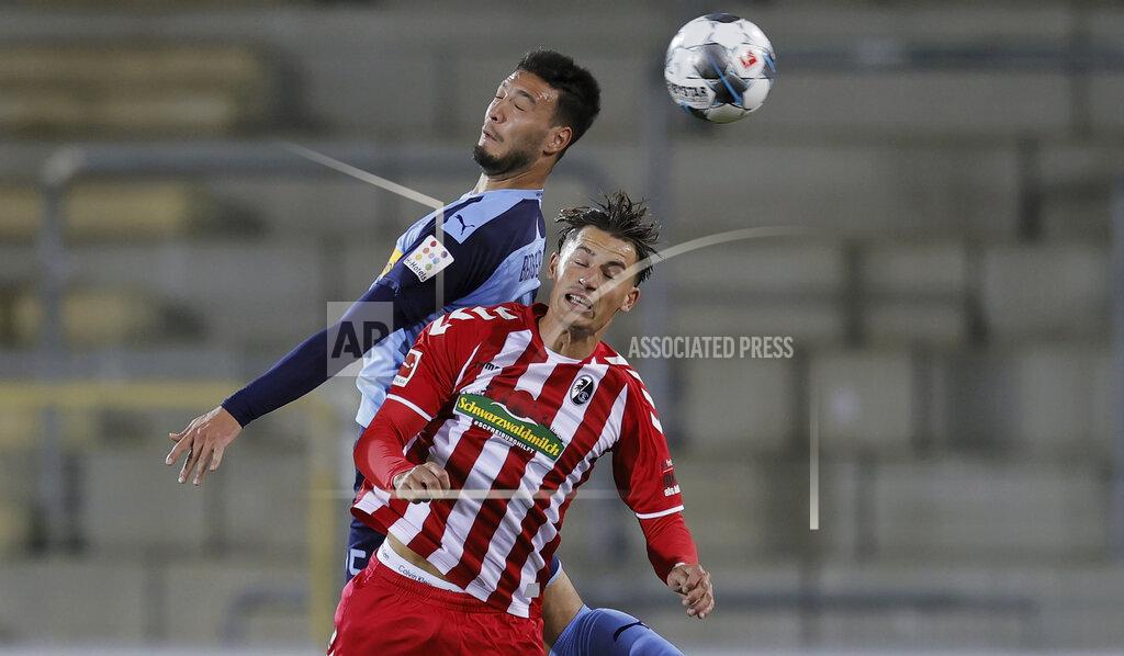 Ronald Wittek Moenchengladbach's Ramy Bensebaini, left, and Freiburg's Robin Koch, right, head for the during during the German Bundesliga soccer match between SC Freiburg and Borussia Moenchengladbach in Freiburg, Germany, Friday, June 5, 2020. Because of the coronavirus outbreak all soccer matches of the German Bundesliga take place without spectators. (Ronald Wittek/Pool via AP)