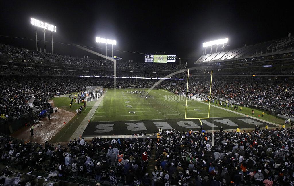 Jeff Chiu FILE - In this Dec. 24, 2018, file photo, fans watch from a general view at Oakland Alameda County Coliseum during the second half of an NFL football game between the Oakland Raiders and the Denver Broncos in Oakland, Calif. It will be the end of an era of sorts this weekend in Oakland. Not that anyone figures to be mourning what should be the final NFL game ever played on a field with infield dirt, especially the players who have had to deal with the bad footing, ripped jerseys, scraped arms and legs and hard falls onto a surface with no cushion. (AP Photo/Jeff Chiu, File)
