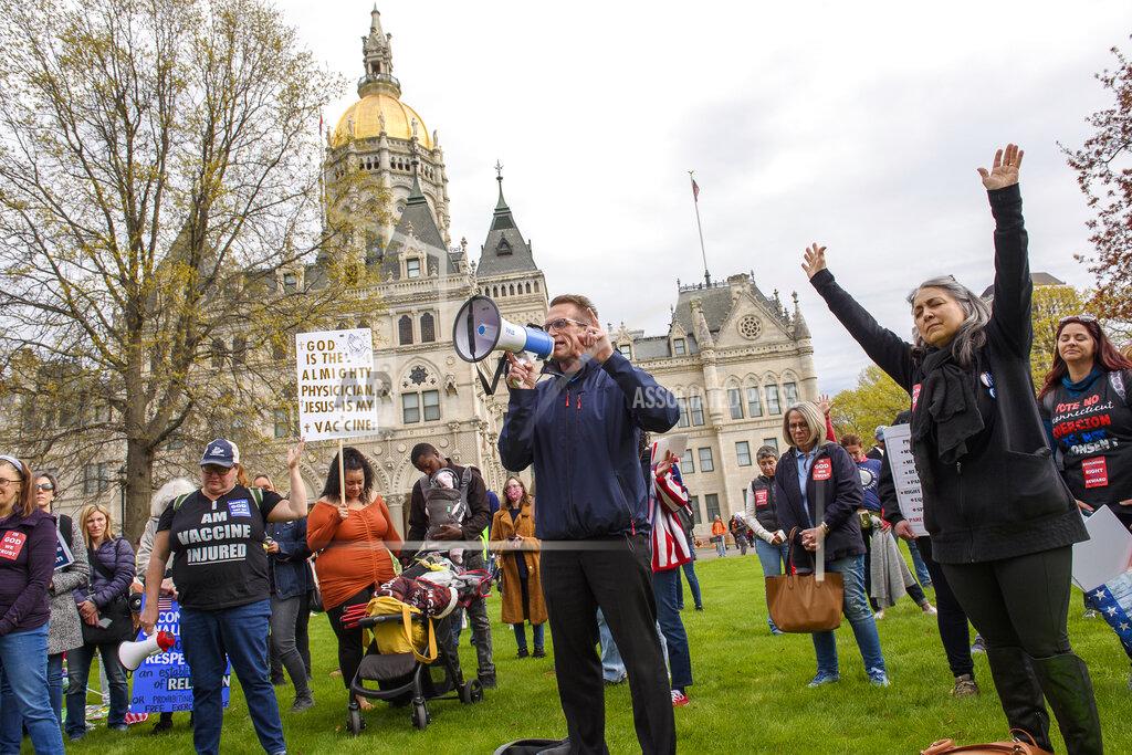 Mark Mirko Joining thousands gathered outside the State Capitol, opponents of a bill to repeal Connecticut's religious exemption for school vaccinations pray outside the Capitol before the State Senate voted on the legislation, Tuesday, April 27, 2021, in Hartford, Conn. Religious exemptions like the one eliminated by Connecticut’s new law are facing particular scrutiny amid fears of new measles outbreaks and concerns the growing number of families claiming religious exemptions for their children are opposed because of scientifically discredited claims about the dangers of vaccines. (Mark Mirko/Hartford Courant via AP)