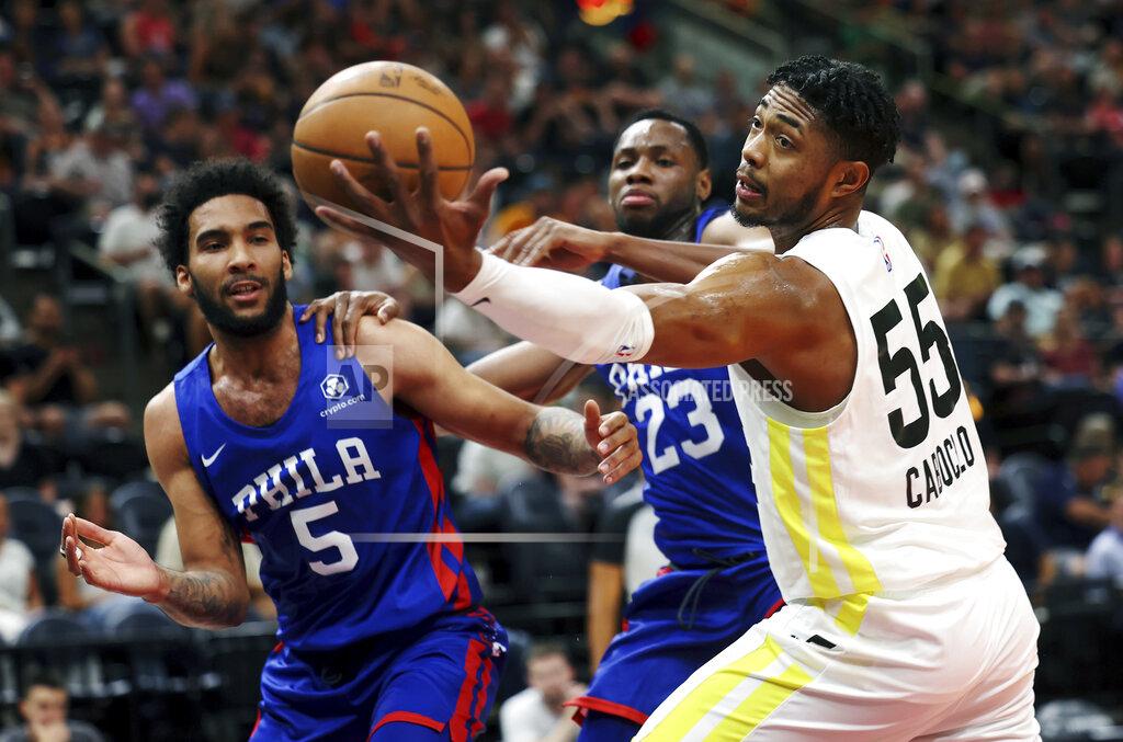 Scott G. Winterton Utah Jazz' Bruno Caboclo (55) reaches for a rebound ahead of Philadelphia 76's Julian Champagnie (5) and Charles Bassey (23) during a summer league basketball game in Salt Lake City on Wednesday, July 6, 2022. (Scott G. Winterton/The Deseret News via AP)