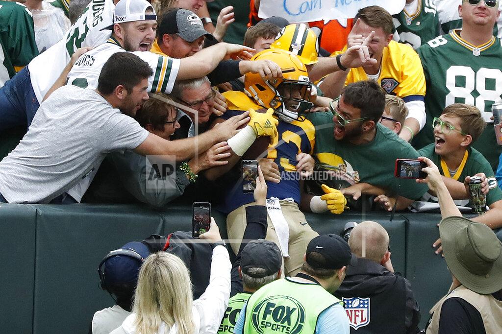 Matt Ludtke Green Bay Packers running back Aaron Jones is congratulated by fans after scoring during the second half of an NFL football game against the Denver Broncos, Sunday, Sept. 22, 2019, in Green Bay, Wis. (AP Photo/Matt Ludtke)