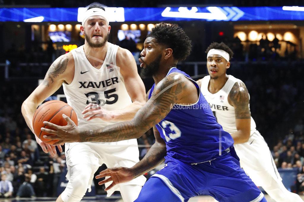 John Minchillo Seton Hall's Myles Powell (13) passes the ball as Xavier's Zach Hankins (35) defends during the second half of an NCAA college basketball game Wednesday, Jan. 2, 2019, in Cincinnati. (AP Photo/John Minchillo)