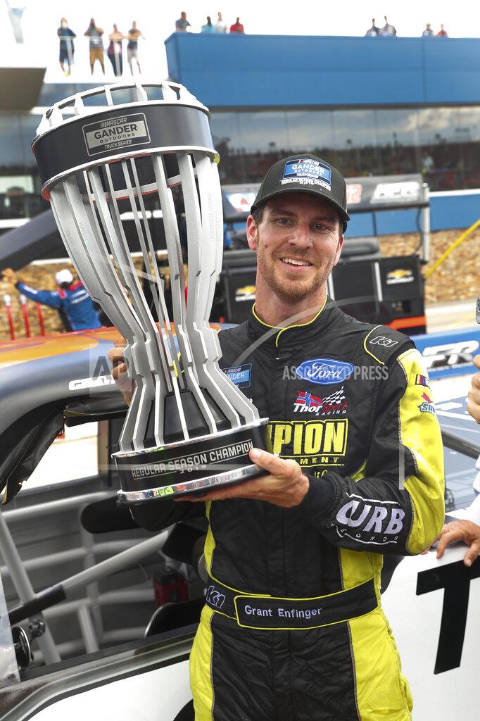 Paul Sancya Grant Enfinger celebrates his regular-season championship for the Gander Outdoors Truck Series after a NASCAR Truck Series race at Michigan International Speedway in Brooklyn, Mich., Saturday, Aug. 10, 2019. (AP Photo/Paul Sancya)