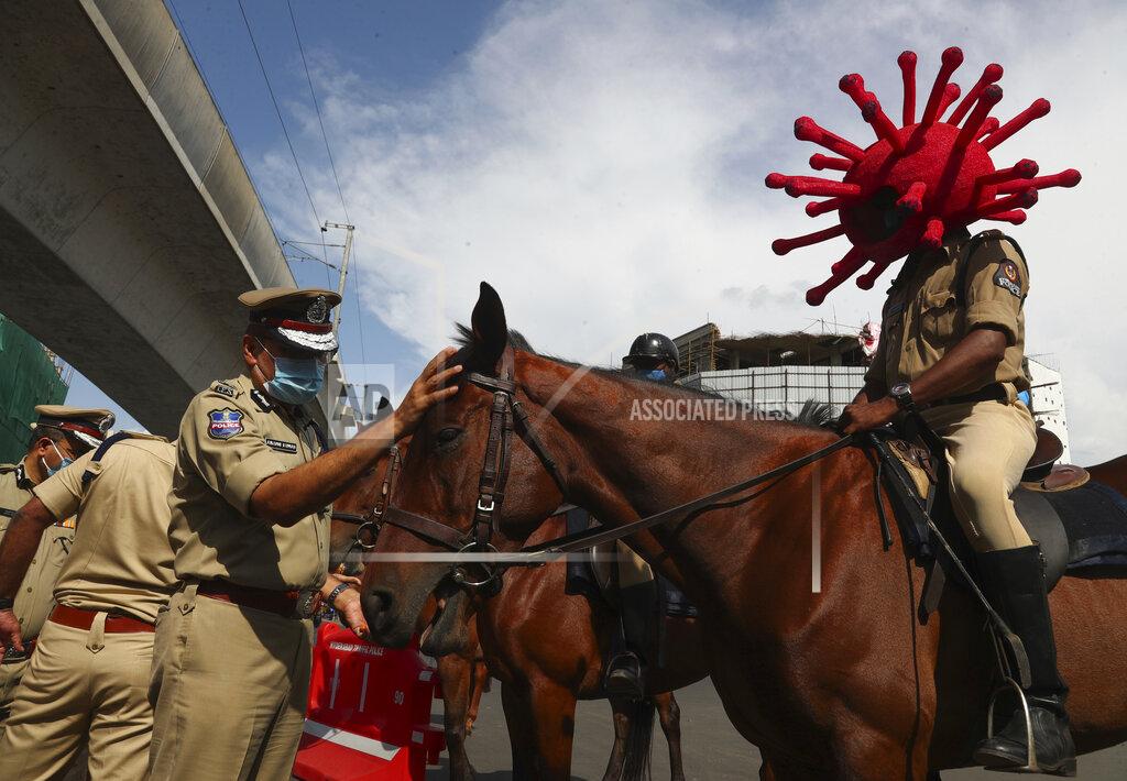Mahesh Kumar A A policeman rides a horse wearing a virus-themed helmet during a COVID-19 awareness drive in Hyderabad, India, Tuesday, June 1, 2021. (AP Photo/Mahesh Kumar A.)