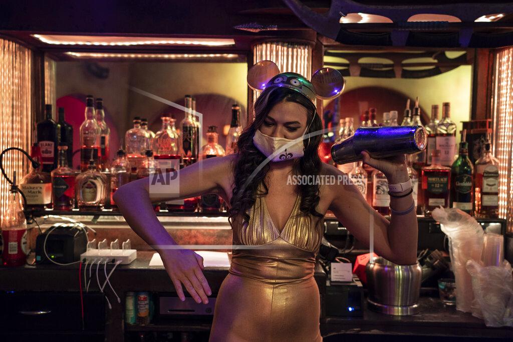 Jae C. Hong Dressed in a Star Wars theme to celebrate Star Wars Day, bartender Karissa Marston jokingly strikes a pose while making a cocktail for a customer at Scum and Villainy Cantina, a geek bar located on Hollywood Blvd, in Los Angeles, Tuesday, May 4, 2021. California has the lowest infection rate in the country. Los Angeles County, which is home to a quarter of the state's nearly 40 million people and has endured a disproportionate number of the state's 60,000 deaths, didn't record a single COVID-19 death Sunday or Monday, which was likely due to incomplete weekend reporting but still noteworthy. (AP Photo/Jae C. Hong)