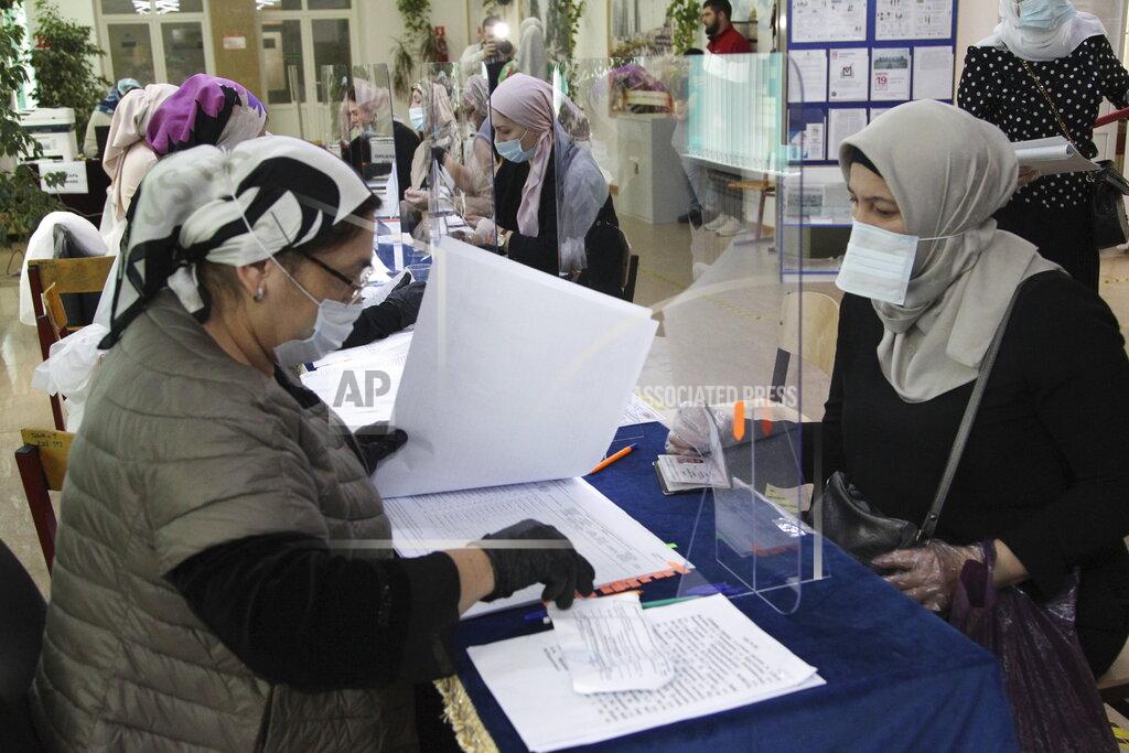 Musa Sadulayev Chechen women receive their ballots at a polling station during the Parliamentary elections in Grozny, Russia, Saturday, Sept. 18, 2021. Sunday will be the last of three days voting for a new parliament, but there seems to be no expectation that United Russia, the party devoted to President Vladimir Putin, will lose its dominance in the State Duma. (AP Photo/Musa Sadulayev)