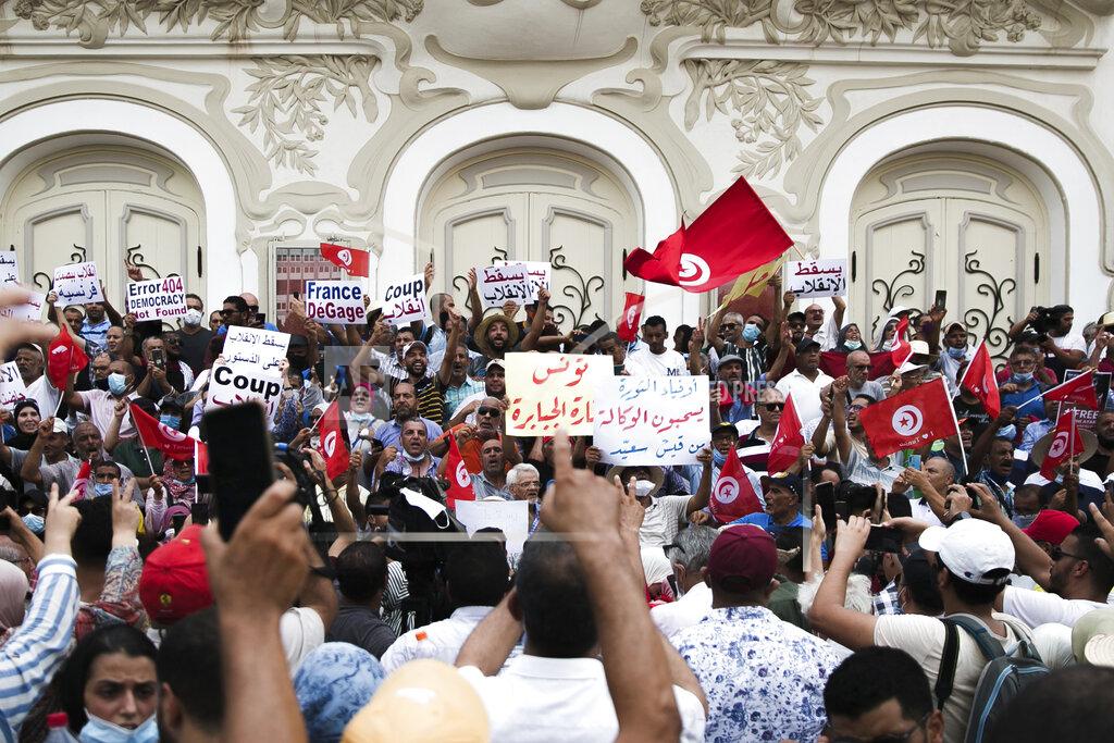 Riadh Dridi Tunisian demonstrators gather outside the Municipal Theatre of Tunis during a protest against Tunisian President Kais Saied, Saturday, Sept. 18, 2021. In July Tunisian President Kais Saied fired the country's prime minister and froze parliament's activities after violent demonstrations over the country's pandemic and economic situation. The movement made by Saied was considered by his opponents as a coup. (AP Photo/Riadh Dridi)