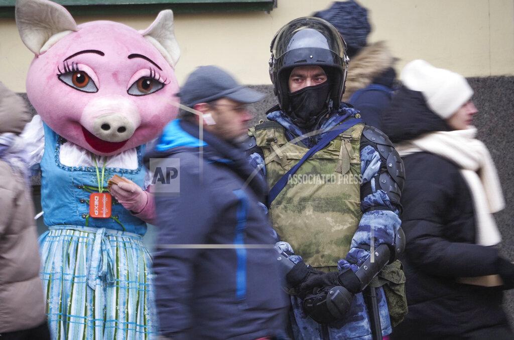 Dmitri Lovetsky A Russian Rosguardia (National Guard) soldier stands at a central avenue in front of a restaurant promoter, a day before Sunday's protest in St. Petersburg, Russia, Saturday, Jan. 30, 2021. As part of a multipronged effort by the authorities to discourage Russians from attending Sunday's demonstrations, the Prosecutor General's office ordered the state communications watchdog, Roskomnadzor, to block the calls for joining the protests on the internet. The Prosecutor General's office and the Interior Ministry also issued stern warnings to the public not to join the protests, saying participants could face criminal charges of taking part in mass riots if the rallies turn violent. (AP Photo/Dmitri Lovetsky)