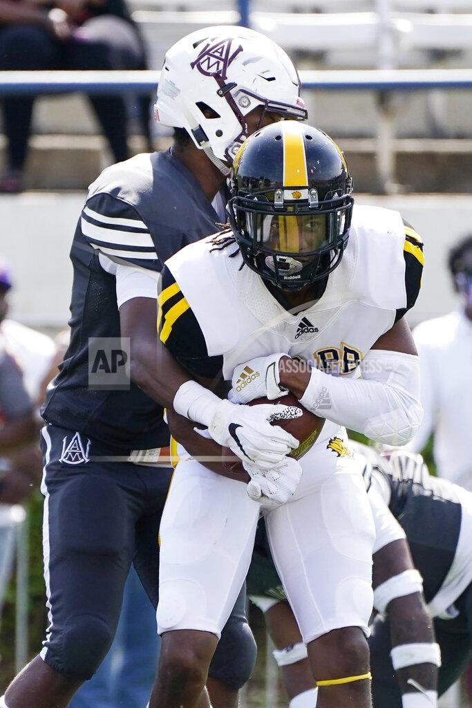 Rogelio V. Solis Arkansas-Pine Bluff wide receiver DeJuan Miller (13) holds on to a touchdown pass reception in front of an Alabama A&M defender during the first half of the Southwestern Athletic Conference NCAA college football game, Saturday, May 1, 2021, in Jackson, Miss. (AP Photo/Rogelio V. Solis)