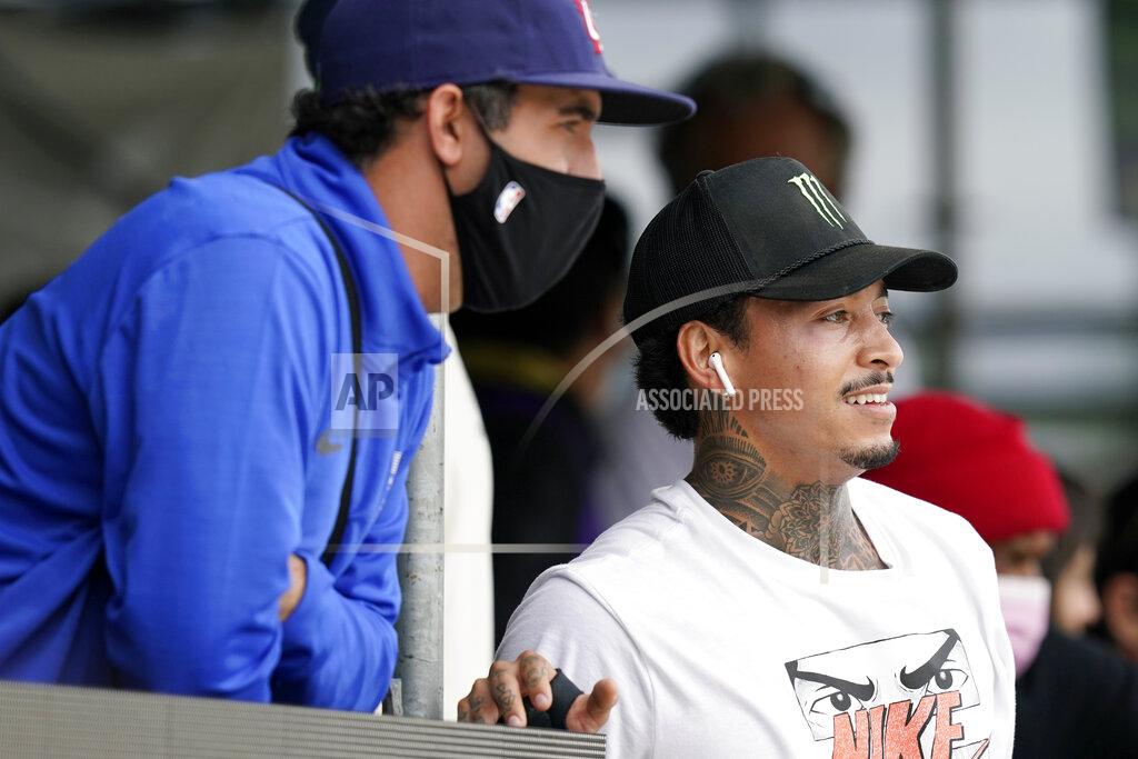 Charlie Neibergall Nyjah Huston, of the United States, right, looks on during practice for an Olympic qualifying skateboard event at Lauridsen Skatepark, Saturday, May 22, 2021, in Des Moines, Iowa. The questions under the magnifying glass at this week's Dew Tour — one of the last major qualifying events for the games in Tokyo in July — is whether the Olympics is ready for skateboarding and, more tellingly, whether skateboarding is ready for the Olympics. (AP Photo/Charlie Neibergall)