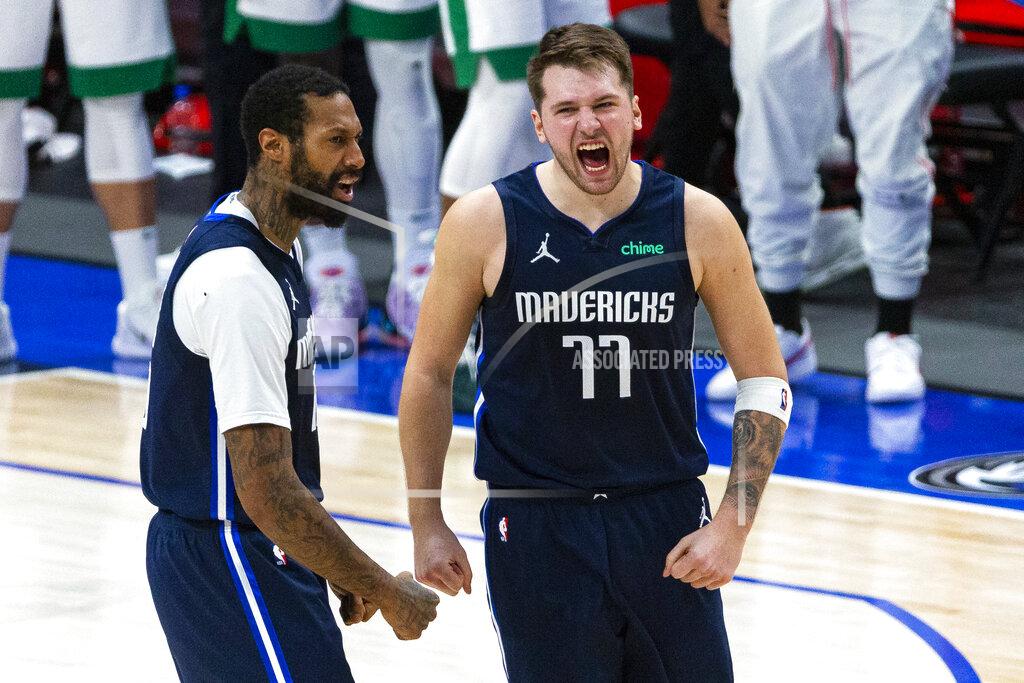 Sam Hodde Dallas Mavericks guard Luka Doncic (77) celebrates with teammate James Johnson (16) after making a 3-point basket during the second half of an NBA basketball game against the Boston Celtics in Dallas, Tuesday, Feb. 23, 2021. (AP Photo/Sam Hodde)