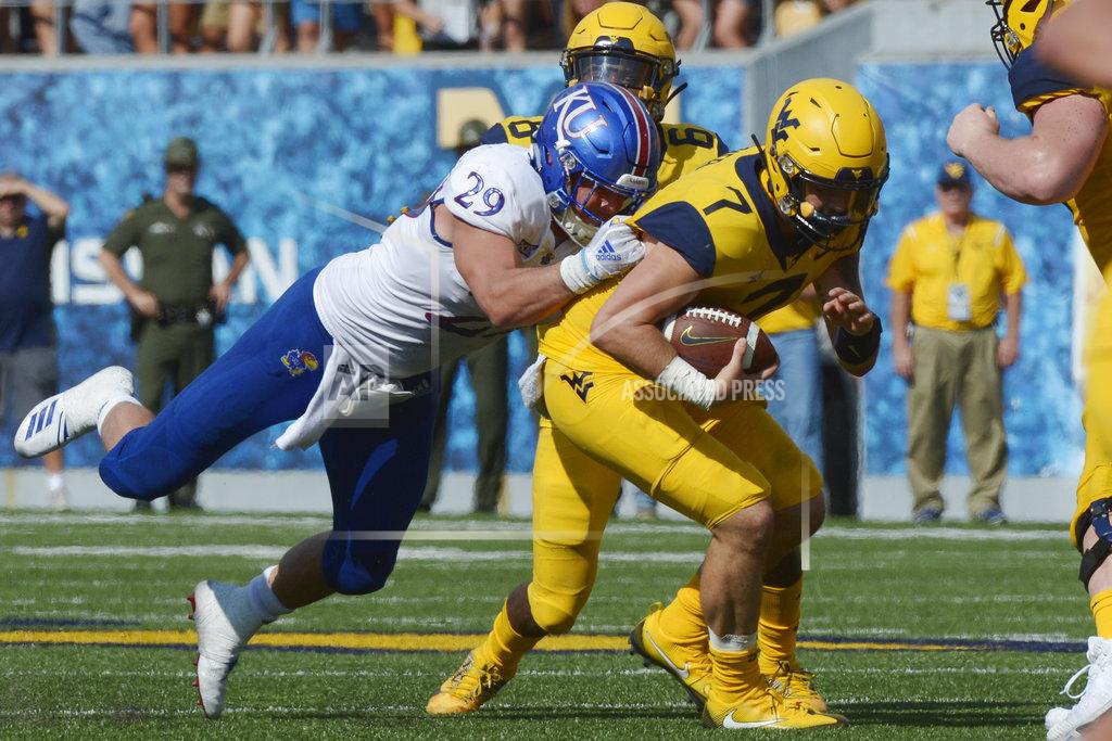 Craig Hudson West Virginia quarterback Will Grier (7) is tackled by Kansas linebacker Joe Dineen Jr. (29) during the second half of an NCAA college football game against Kansas in Morgantown, W. Va., Saturday Oct. 6, 2018. (AP Photo/Craig Hudson)