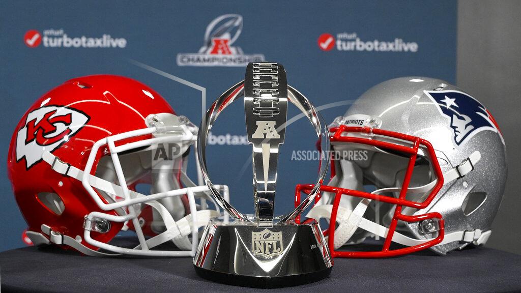 John Sleezer The Lamar Hunt Trophy stands between helmets of the Kansas City Chiefs and the New England Patriots, during a news conference Wednesday, Jan. 16, 2019, in Kansas City, Mo. The Chiefs are scheduled to play the Patriots for the NFL football AFC championship Sunday. (John Sleezer/The Kansas City Star via AP)