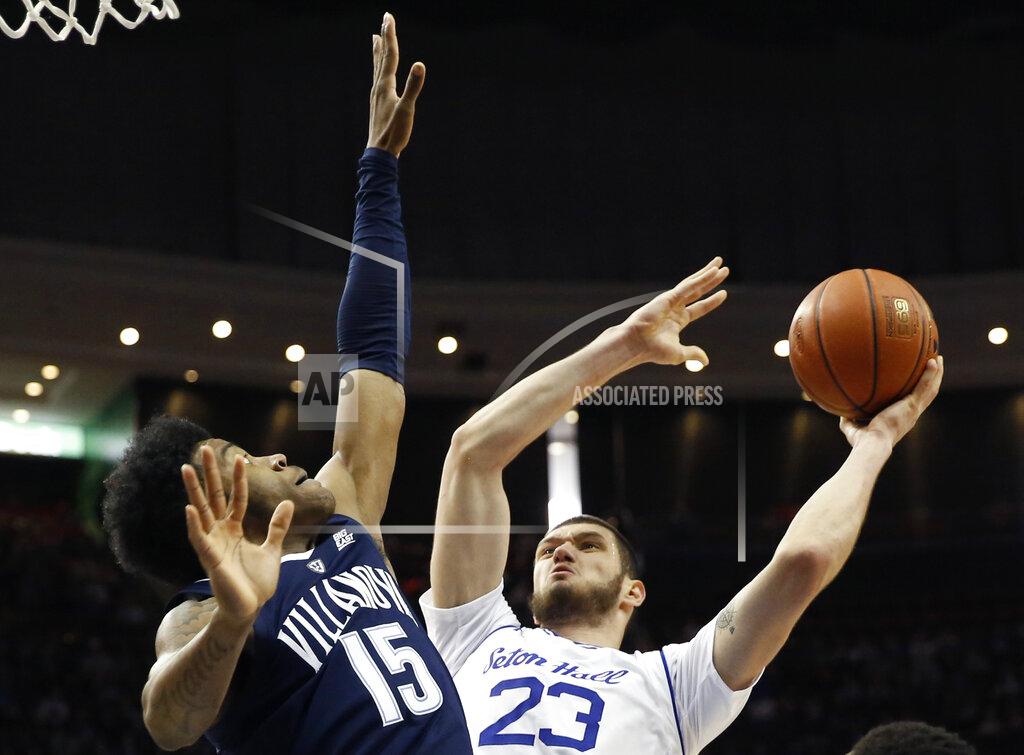 Kathy Willens FILE - In this March 9, 2019, file photo, Villanova forward Saddiq Bey (15) defends Seton Hall forward Sandro Mamukelashvili (23) who goes up for a layup during the second half of an NCAA college basketball game in Newark, N.J. Mamukelashvili, at 6-11, is expected to move from the starting center spot for his more natural position at power forward. (AP Photo/Kathy Willens, File)